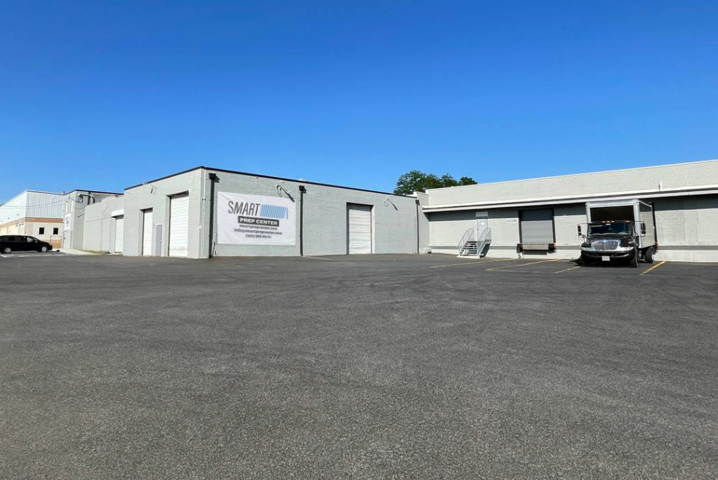 Exterior view of Smart Prep Center warehouse and headquarters, showcasing the main building and loading area.