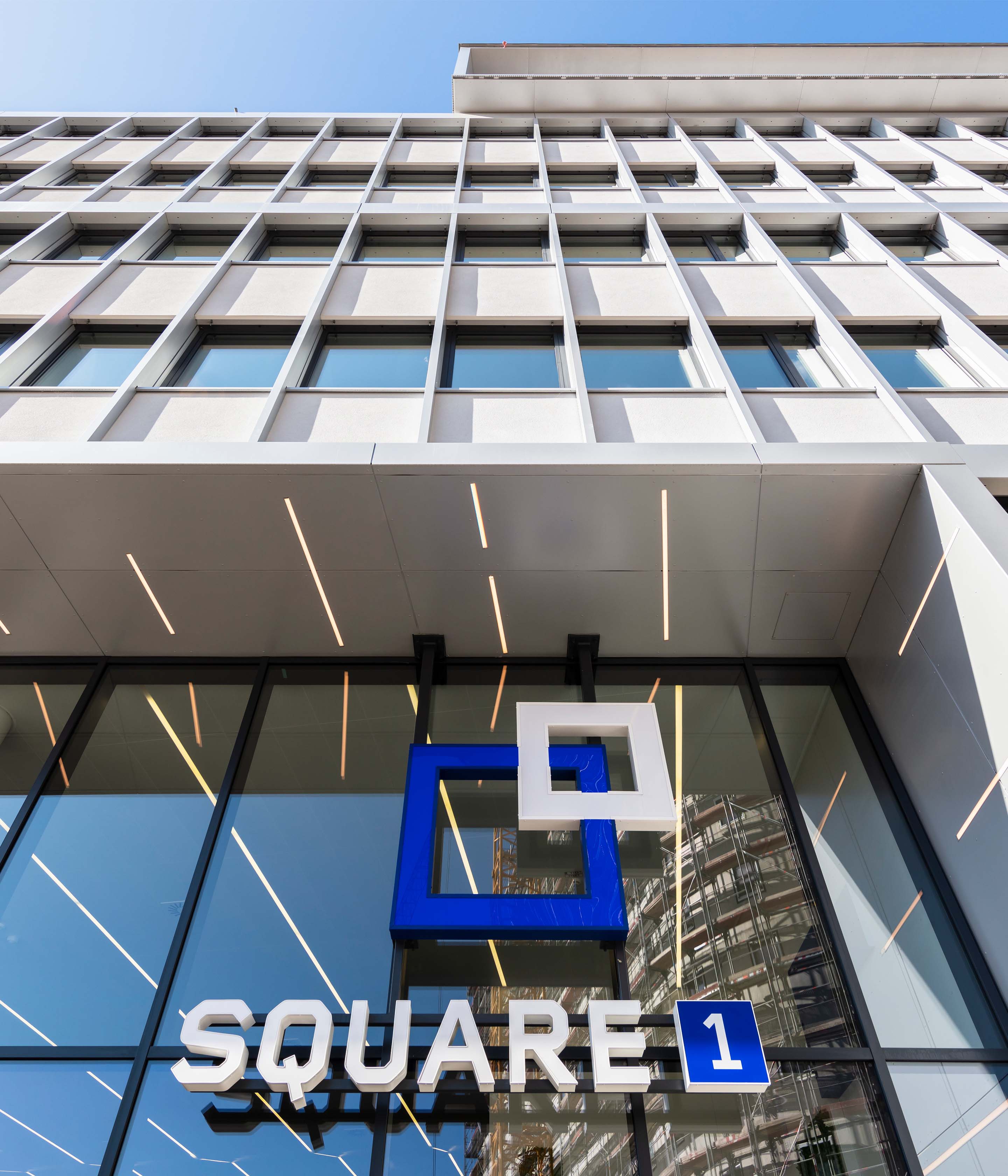 Exterior view of Square1 headquarters building, showcasing modern architectural design with the company's logo prominently displayed.