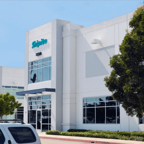 ShipTo Partners headquarters and warehouse exterior featuring modern architecture and large windows.