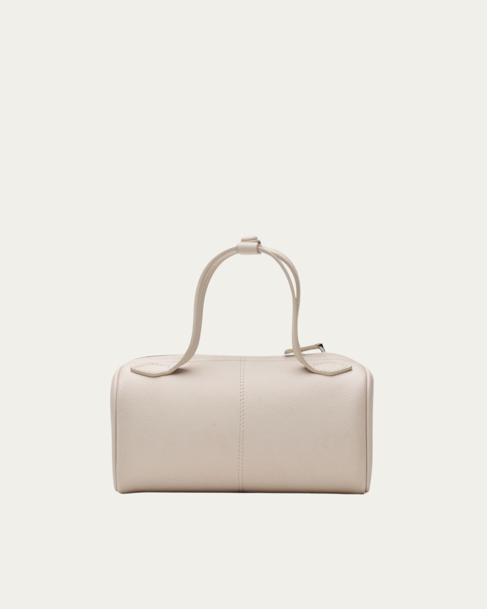 Freja New York's brand identity embodies sophisticated minimalism with a focus on clean, contemporary design. The website features a neutral color palette dominated by soft oats, warm espressos, and clean whites that reflect their product aesthetic. Product photography is professional and editorial in style, showcasing handbags against minimal backgrounds and in lifestyle settings including Paris campaign shoots. The bags themselves feature sleek, geometric silhouettes with smooth leather textures and minimal hardware details. The overall visual presentation is luxurious yet understated, with generous white space and elegant typography that emphasizes the premium quality of their leather goods. The brand's visual language communicates timeless sophistication and modern femininity through its refined aesthetic choices.