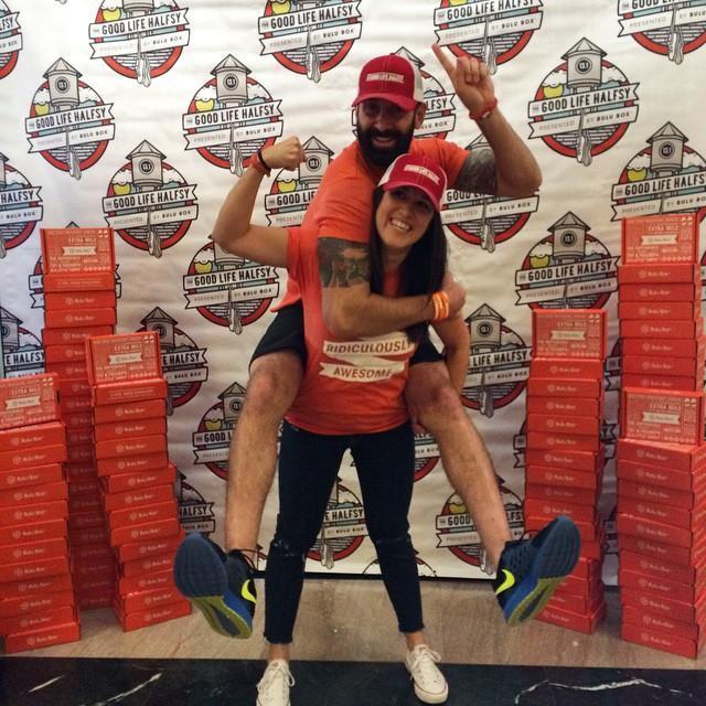 Paul Jarrett and co-founder Stephanie in front of stacked Bulu boxes at the Good Life Halfsy